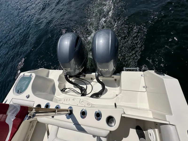 Slide: The Image of 2016 Sailfish 270 CC boat with twin outboard engines on water. - 11