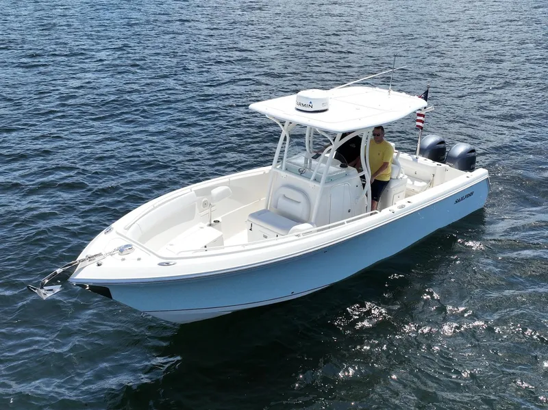 Slide: The Image of 2016 Sailfish 270 CC boat on open water. - 12