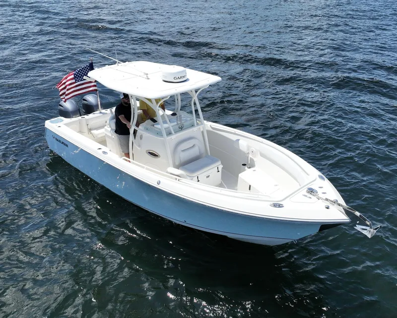 Slide: The Image of 2016 Sailfish 270 CC boat cruising on open water. - 13
