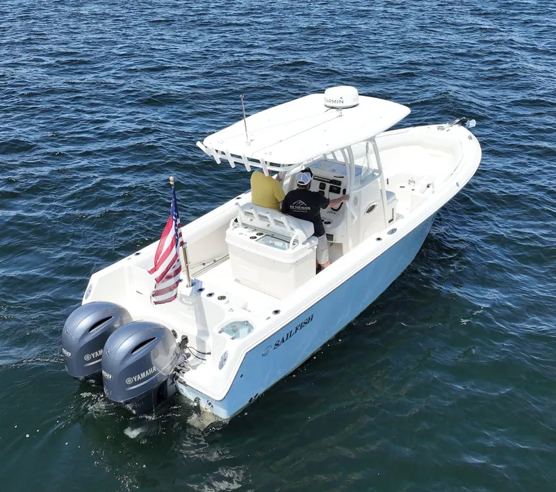 Slide: The Image of 2016 Sailfish 270 CC boat with dual Yamaha engines on open water. - 14