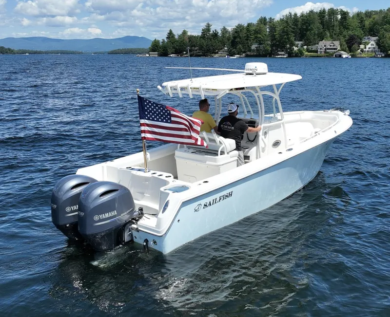 Slide: The Image of 2016 Sailfish 270 CC boat with dual Yamaha engines on a lake. - 16