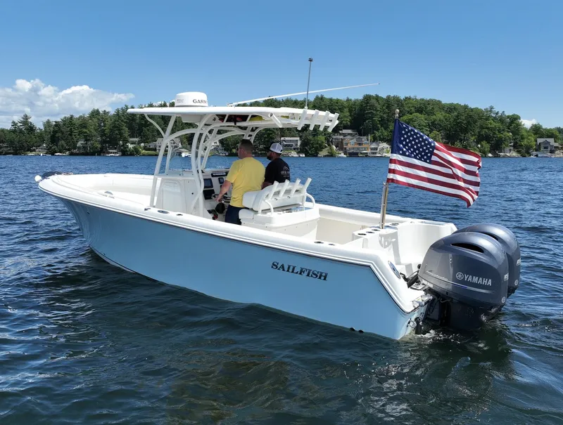 Slide: The Image of 2016 Sailfish 270 CC boat on a lake with American flag and Yamaha motor. - 17
