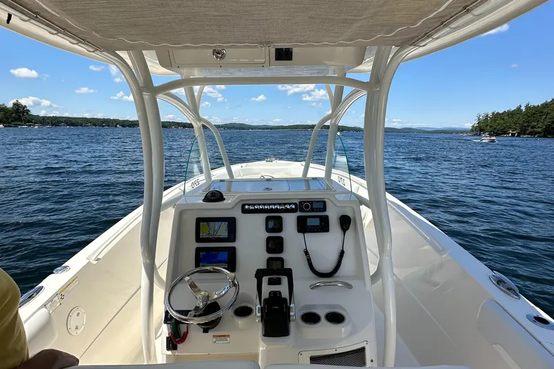 Slide: The Image of 2016 Sailfish 270 CC boat console on a scenic lake. - 21