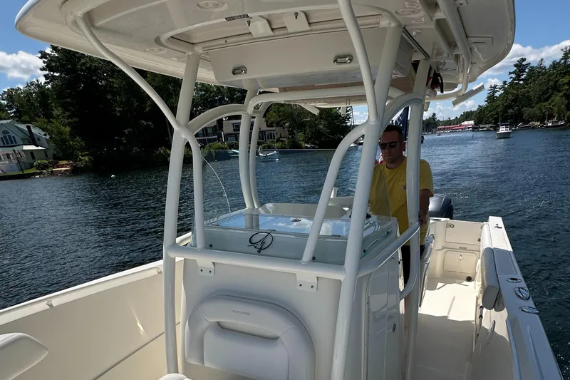 Slide: The Image of Man steering 2016 Sailfish 270 CC boat on a scenic lake. - 23