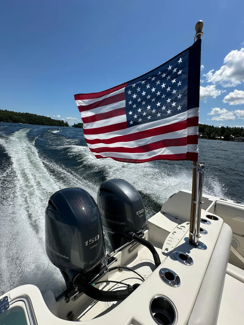 Slide: The Image of 2016 Sailfish 270 CC boat with dual Yamaha 150 engines and American flag. - 27