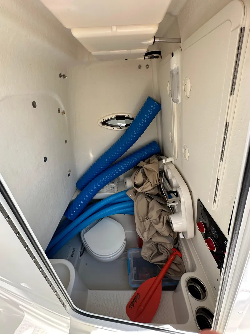 Slide: The Image of Storage compartment of a 2016 Sailfish 270 CC boat with various boating accessories. - 29