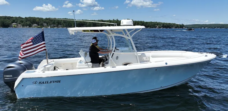 Slide: The Image of 2016 Sailfish 270 CC boat cruising on a lake with an American flag. - 3