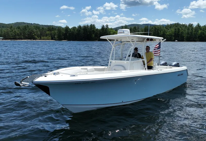 Slide: The Image of 2016 Sailfish 270 CC boat on a lake with two people onboard. - 5