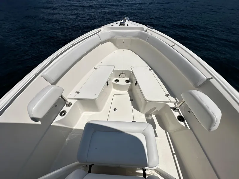 Slide: The Image of 2016 Sailfish 270 CC boat interior with white seating and storage compartments. - 7