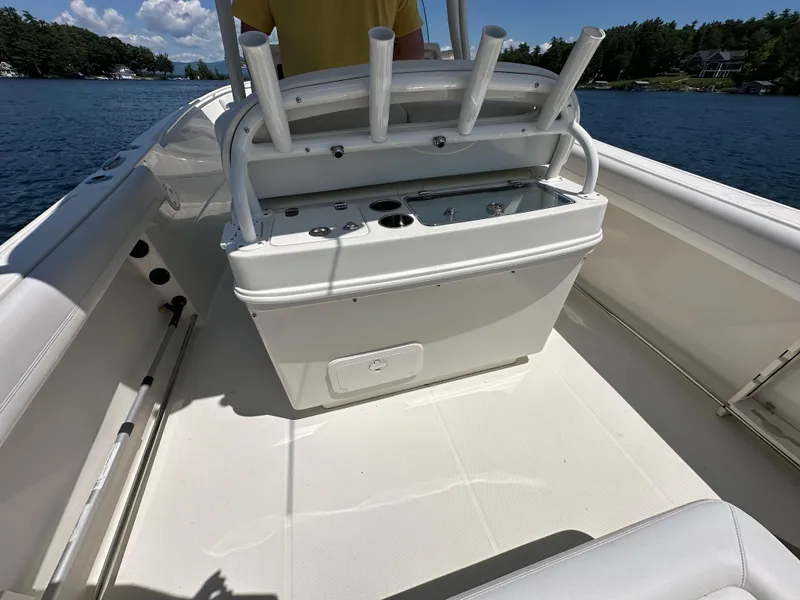 Slide: The Image of 2016 Sailfish 270 CC boat interior with rod holders and storage compartments. - 9