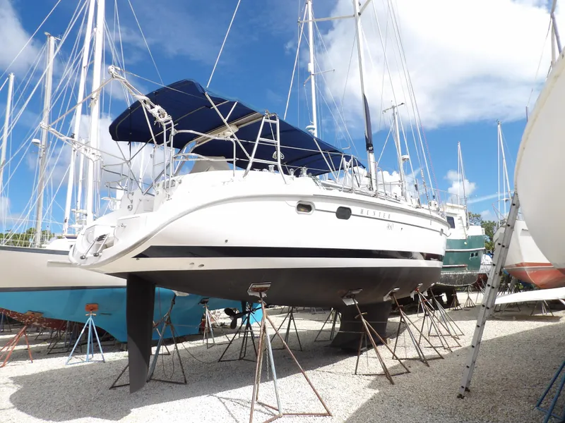 Slide: The Image of Hunter 460 sailboat, 2000 model, on stands in a boatyard under a clear blue sky. - 1