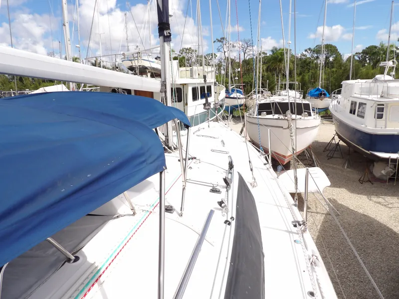 Slide: The Image of Hunter 460 sailboat, 2000 model, docked among other boats under a clear sky. - 15