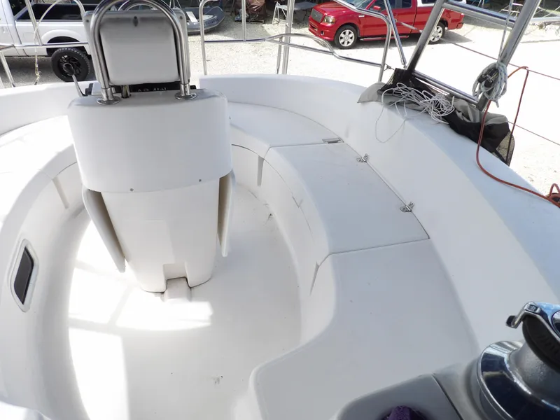 Slide: The Image of Cockpit view of a 2000 Hunter 460 sailboat with white seating and steering console. - 22
