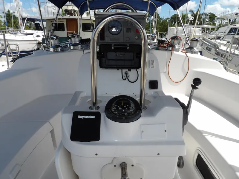 Slide: The Image of Hunter 460 sailboat cockpit with navigation equipment, compass, and steering wheel, year 2000 model. - 26