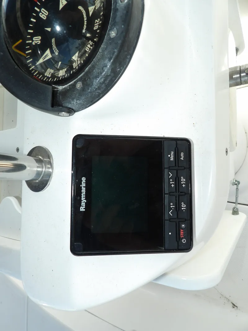 Slide: The Image of 2000 Hunter 460 boat dashboard with Raymarine display and compass. - 27