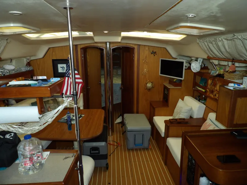 Slide: The Image of Interior of a 2000 Hunter 460 sailboat with wooden furnishings and cozy seating. - 38
