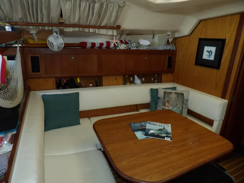 Slide: The Image of Interior of 2000 Hunter 460 sailboat with cozy dining area and wooden table. - 39