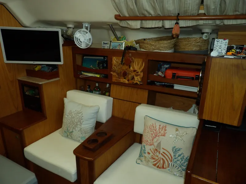 Slide: The Image of Interior of a 2000 Hunter 460 sailboat with cozy seating and nautical decor. - 41