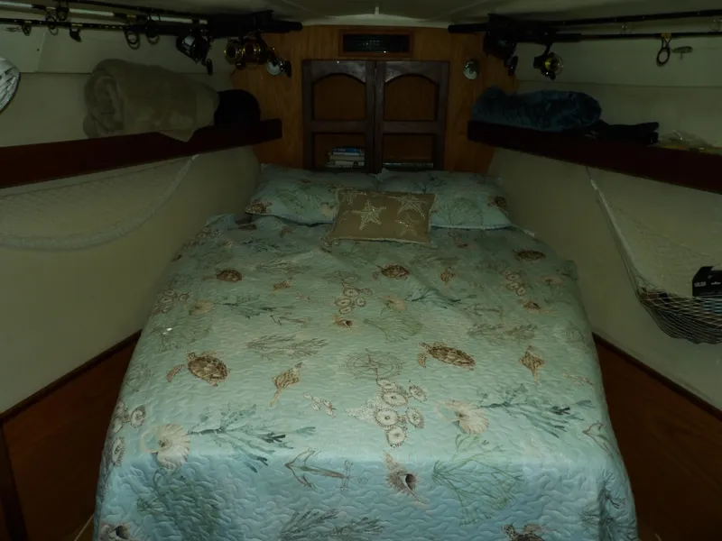 Slide: The Image of Cozy cabin interior of a 2000 Hunter 460 sailboat with a neatly made bed. - 43