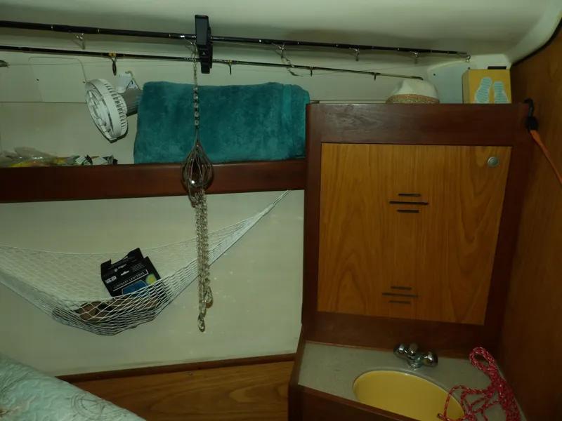 Slide: The Image of Interior of a 2000 Hunter 460 sailboat with storage and sink. - 45