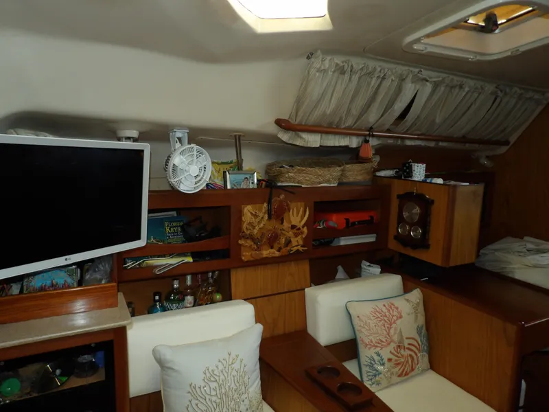 Slide: The Image of Interior of 2000 Hunter 460 sailboat with cozy seating and wooden cabinetry. - 48