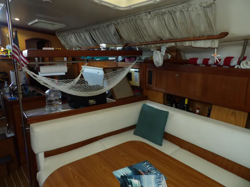 Slide: The Image of Interior of a 2000 Hunter 460 sailboat with dining area and hammock. - 49