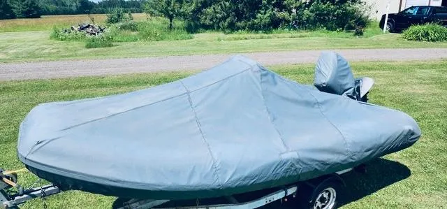 Slide: The Image of Covered 2004 AB Inflatables Oceanus 4.30VST boat on trailer in grassy area. - 6