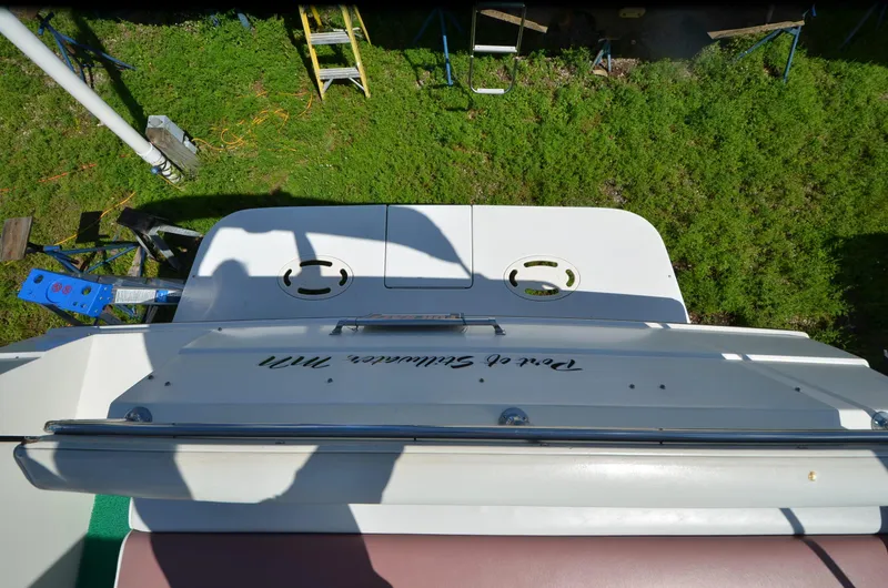 Slide: The Image of 1988 Carver 27 Montego boat deck with shadow, viewed from above, on grassy background. - 14