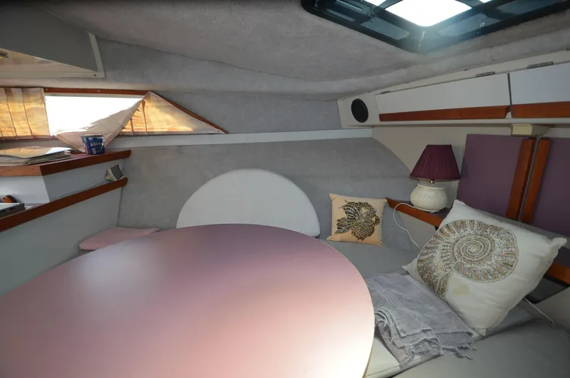 Slide: The Image of Interior of 1988 Carver 27 Montego boat with cozy seating and decorative pillows. - 22