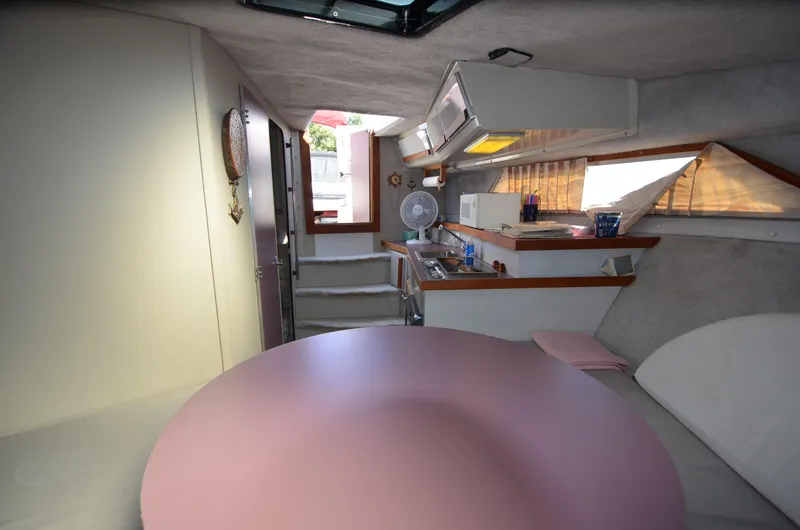Slide: The Image of Interior of 1988 Carver 27 Montego boat with kitchenette and seating area. - 24