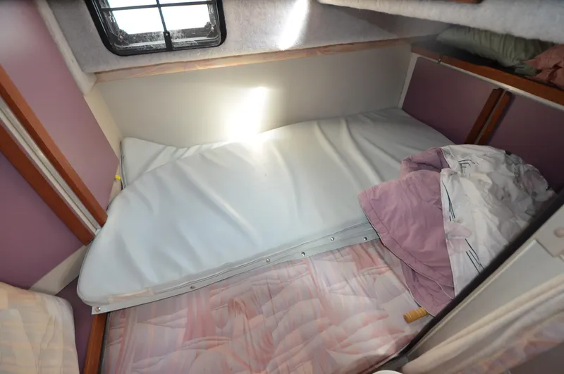 Slide: The Image of Interior cabin of 1988 Carver 27 Montego boat with bed and window. - 25