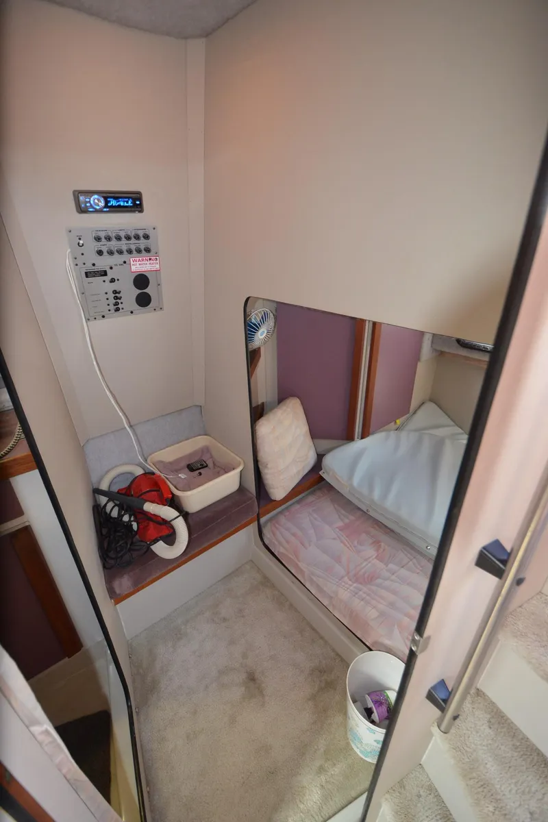 Slide: The Image of 1988 Carver 27 Montego cabin interior with control panel and sleeping area. - 26