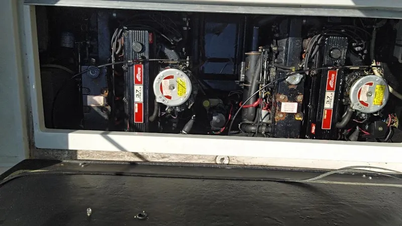 Slide: The Image of Engine compartment of a 1988 Carver 27 Montego boat, showcasing dual engines. - 27