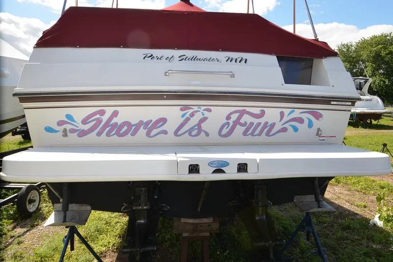 Slide: The Image of 1988 Carver 27 Montego boat with "Shore is Fun" text, docked at Port of Stillwater, MN. - 3