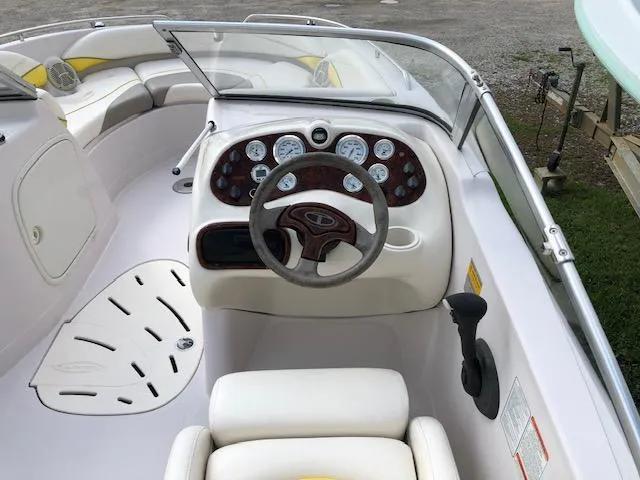 Slide: The Image of 2005 Tahoe Q4 I/O boat cockpit with steering wheel and dashboard controls. - 13
