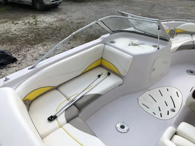 Slide: The Image of 2005 Tahoe Q4 I/O boat interior with white and yellow seating. - 14