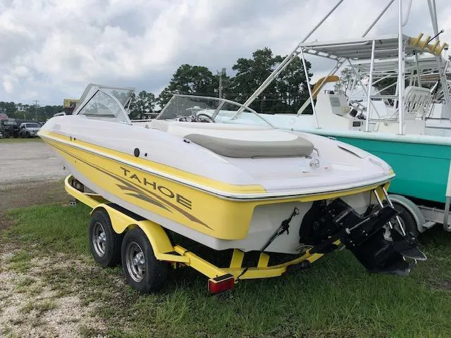 Slide: The Image of 2005 Tahoe Q4 I/O boat with yellow accents on a trailer. - 3