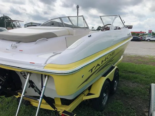 Slide: The Image of 2005 Tahoe Q4 I/O boat with yellow and white exterior on a trailer. - 5