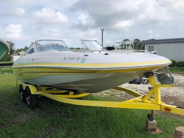 Slide: The Image of 2005 Tahoe Q4 I/O boat on a yellow trailer, parked outdoors. - 6
