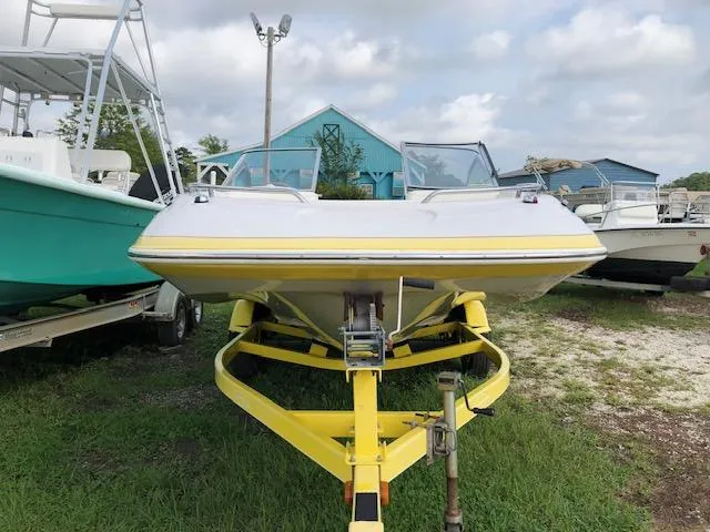 Slide: The Image of 2005 Tahoe Q4 I/O boat on a yellow trailer, parked outdoors. - 7