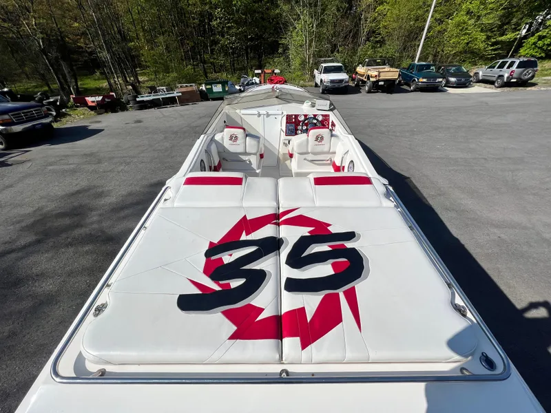 Slide: The Image of 2001 Fountain Lightning Executioner 35 speedboat with custom graphics, parked in a lot. - 1