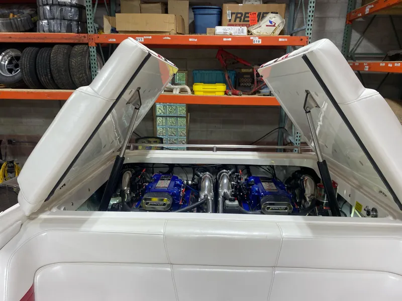 Slide: The Image of 2001 Fountain Lightning Executioner 35 boat engine compartment with twin engines in a garage. - 10