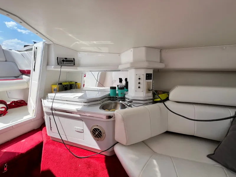 Slide: The Image of Interior of 2001 Fountain Lightning Executioner 35 boat with white seating and red carpet. - 11