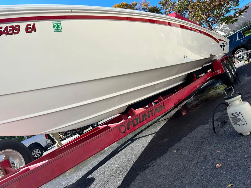 Slide: The Image of 2001 Fountain Lightning Executioner 35 boat on red trailer, side view. - 16