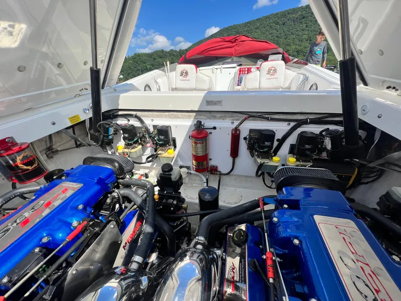 Slide: The Image of 2001 Fountain Lightning Executioner 35 boat engine compartment with dual blue engines. - 19
