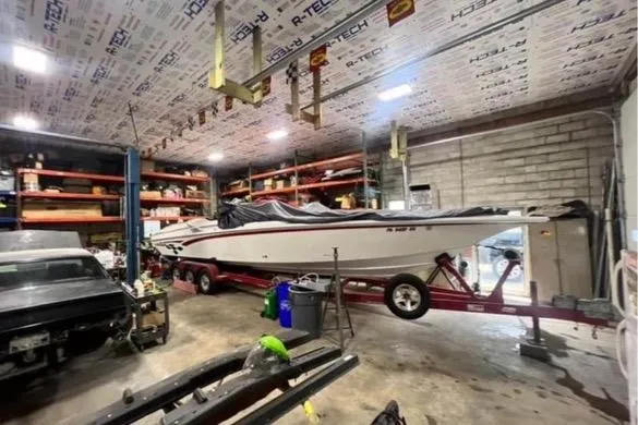 Slide: The Image of 2001 Fountain Lightning Executioner 35 boat in a garage workshop. - 23