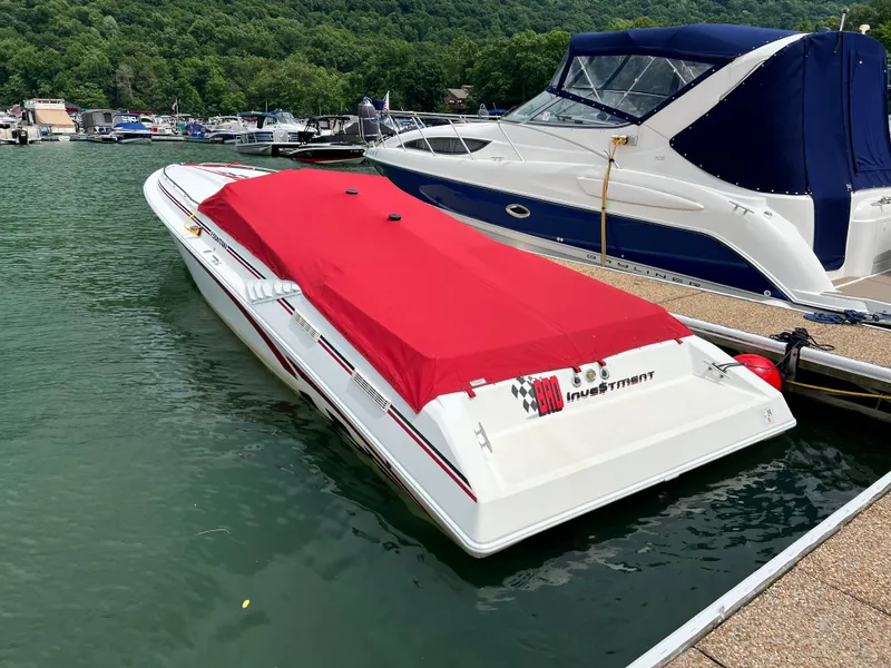 Slide: The Image of 2001 Fountain Lightning Executioner 35 speedboat docked with red cover. - 28