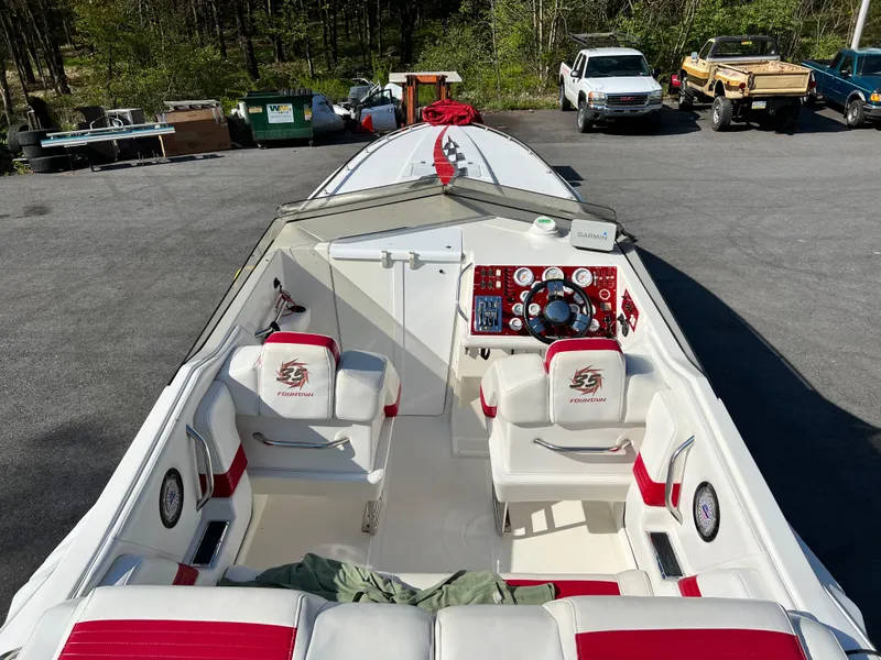 Slide: The Image of 2001 Fountain Lightning Executioner 35 boat interior with red and white seating. - 8