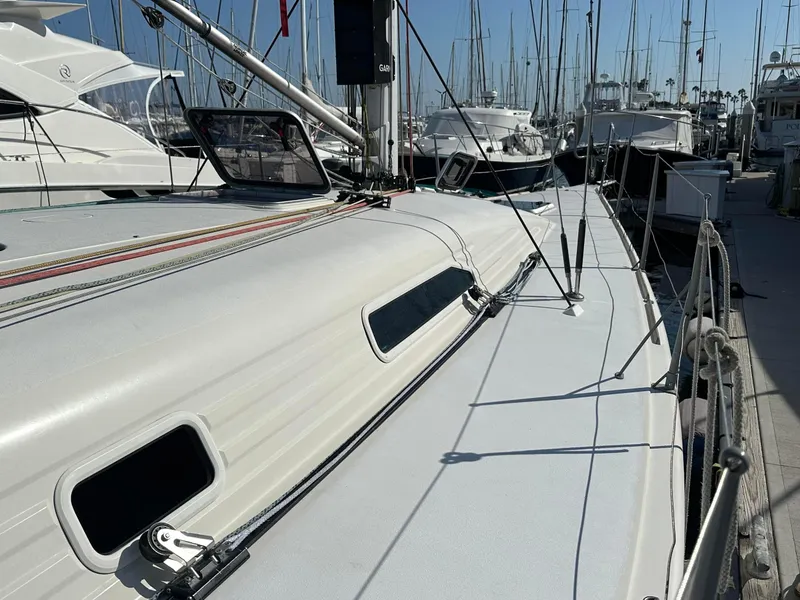 Slide: The Image of 2001 X-Yachts IMX40 sailboat docked in marina, showcasing sleek deck design. - 6