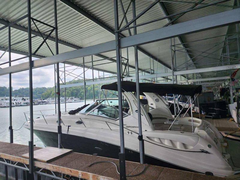 The Image of 2006 Sea Ray 340 Sundancer docked in a covered marina. - 0